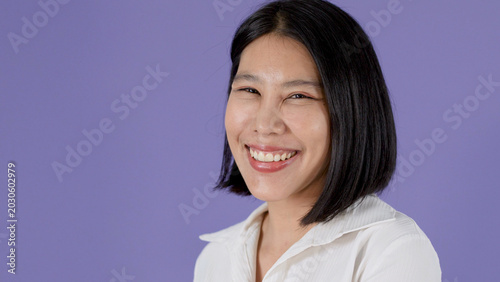 Tableau sur toile Smiling Asian Woman with Bob Haircut Posing Against Purple Background