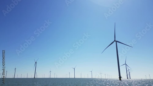 Wind turbines produce energy in the north sea, wind farm power plant view from height, green energy and alternative energy sources.