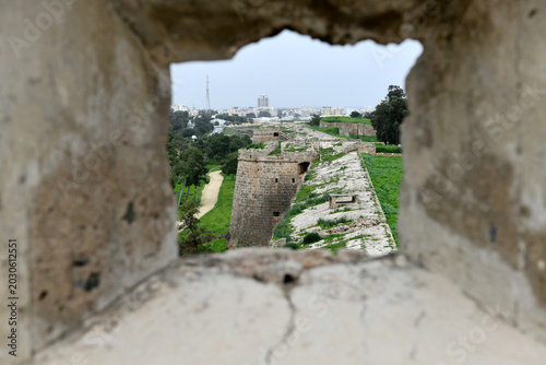 Konstfotografi A framed perspective looking out through a narrow stone window or embrasure of Famagusta Castle