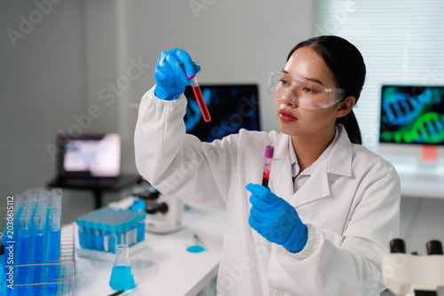 Foto Young Asian woman genetic researcher wearing protective eyewear and gloves, anal