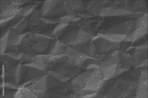 фотографія The crumpled gray surface with white specks is shown close-up indoors