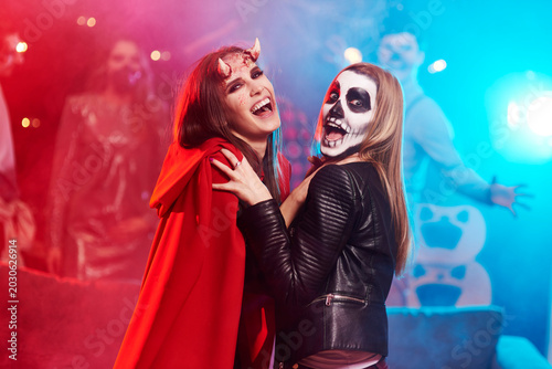 Women in creepy costumes dancing at Halloween party