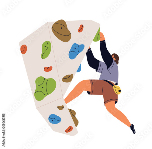 Girl climber hanging on indoor bouldering wall. Female climbing, gripping hol...