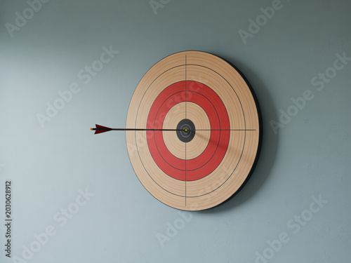 Tableau sur toile Archery target with arrow hitting bullseye on wall for business concept and goal