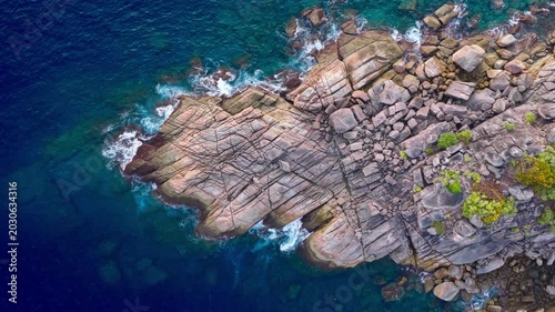 Aerial top view of a tropical paradise beach island with green forest eco system and crystal clear turquoise water and white sand beach background	