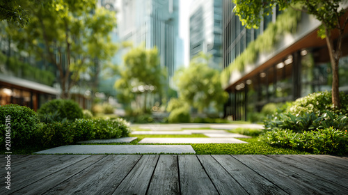 Empty wooden deck foreground with blurred modern green office courtyard background

