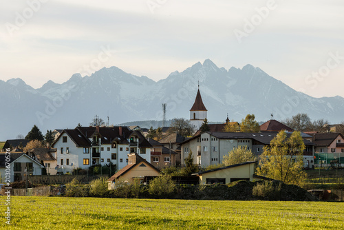 European village houses with snowy High Tatras background