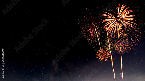 Fotografie Fireworks with blur milky way background