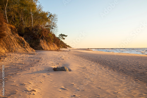Dramatic cliff on the beach in Dziwnowek, Poland, at sunset