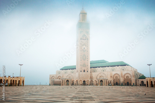 Fotografie Hassan II mosque in Casablanca with high minaret shrouded in light fog