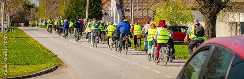Foto Group of cyclists on city road, street, asphalt