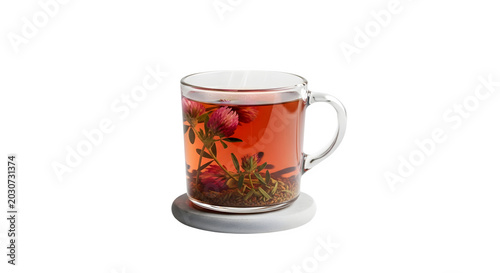 A glass mug with herbal tea and berries on a white coaster