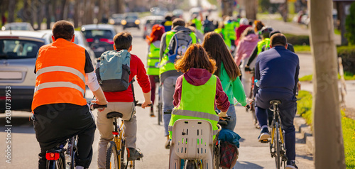 Foto Group of cyclists on city road, street, asphalt