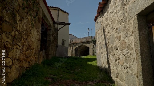 Rural footpath winding between ancient stone buildings