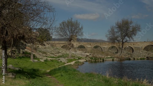 Old stone arch bridge spanning a flowing river