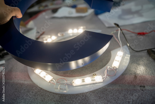 Photos Close-up of illuminated blue acrylic channel letter signage with LED lighting du
