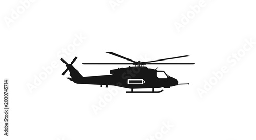 Black helicopter flying in air.
