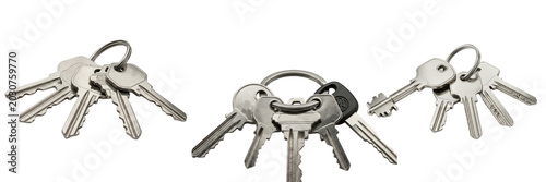 Metallic keyrings with multiple silver keys isolated on white, everyday security and home access objects for real estate, hotel, office and personal lifestyle visuals

