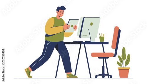 Man working remotely or in a hybrid office standing at a desk with tablet and computer