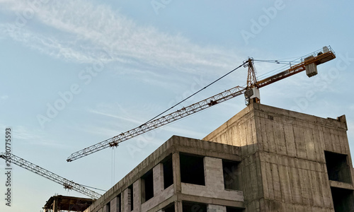 Fotografie Crane and building construction construction site