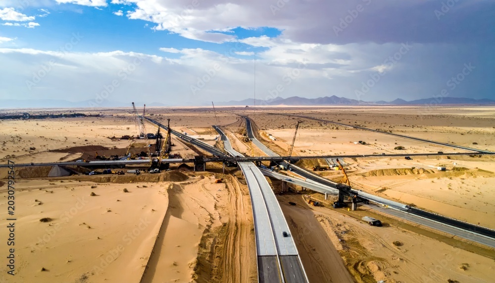 Fototapeta premium Aerial View of Highway Construction in a Desert Landscape.