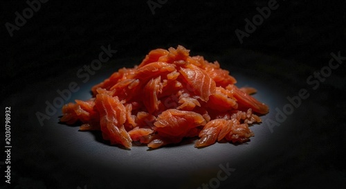 Pile of Flaked Smoked Salmon on a Dark Surface.