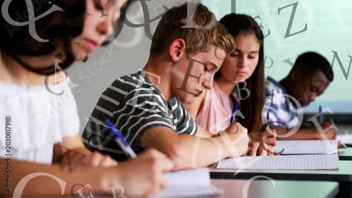 Students writing work after task cue with blue pens, camera pulling back, letters drifting on faces