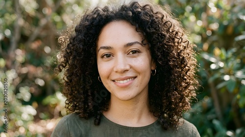 Close-up portrait of woman with natural curly hair and minimal makeup, beauty realism concept