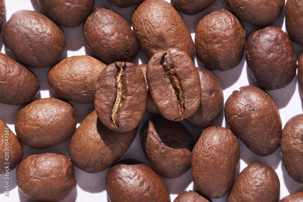 Fototapeta premium Coffee Beans Clustered Closeup Showing Central Split Seams On White Background Studio Macro Flat Lay For Packaging And Quality Inspection.