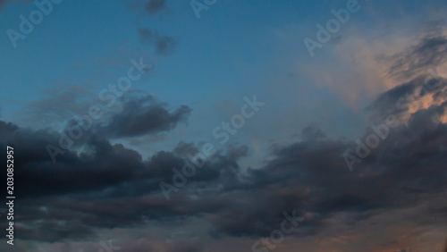 Calm Dusk Sky With Clouds At Twilight, Soft Blue Glow And Orange Hues