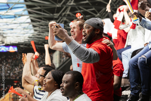 Cuadro en lienzo Diverse fans excited of winning ticket for live betting after final whistle, dramatic football match filled with tension and excitement
