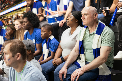 Foto Tense blue team supporters reacting to close call during soccer match in a crowded stadium, wait for final whistle