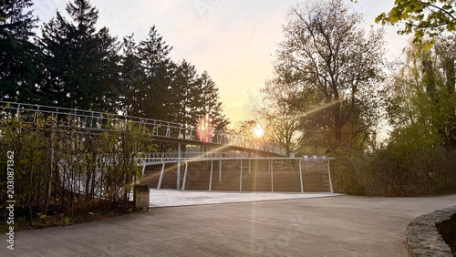Tableau sur toile Beautiful golden hour sun flare over an elevated metal pedestrian bridge in a gr