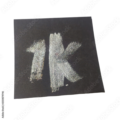 Sparkling rhinestone letter 1k on dark fabric