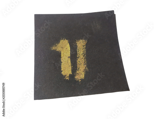 Close-up of a black fabric patch with yellow number eleven