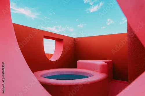 Modern outdoor swimming pool in alien red architecture. Surreal holiday concept with minimalist design. Futuristic luxury vacation residence on another planet under blue sky background.