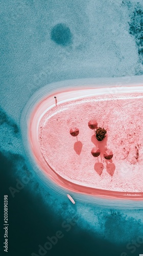 Aerial view of a woman walking on a surreal pink sand island. Fantasy tropical beach with umbrellas and turquoise water. Vacation, space travel, alien planet landscape concept.