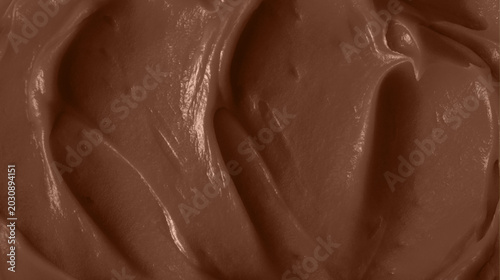 Schilderij op canvas Close up of melted chocolate bar with creamy flowing chocolate swirl, rich brown