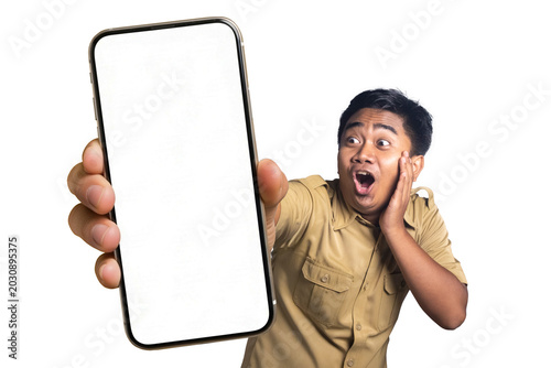 Photos Shocked Indonesian civil servant holding cheek looking at big smartphone white blank mockup screen