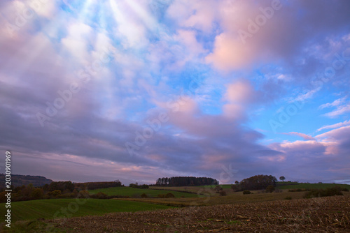 Evening sunshine background with clouds dramatic sky.