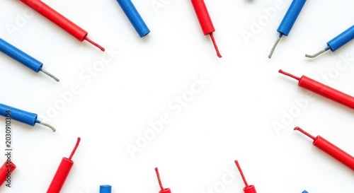 Colorful electric wire connectors in red and blue on white background for electronics and diy projects