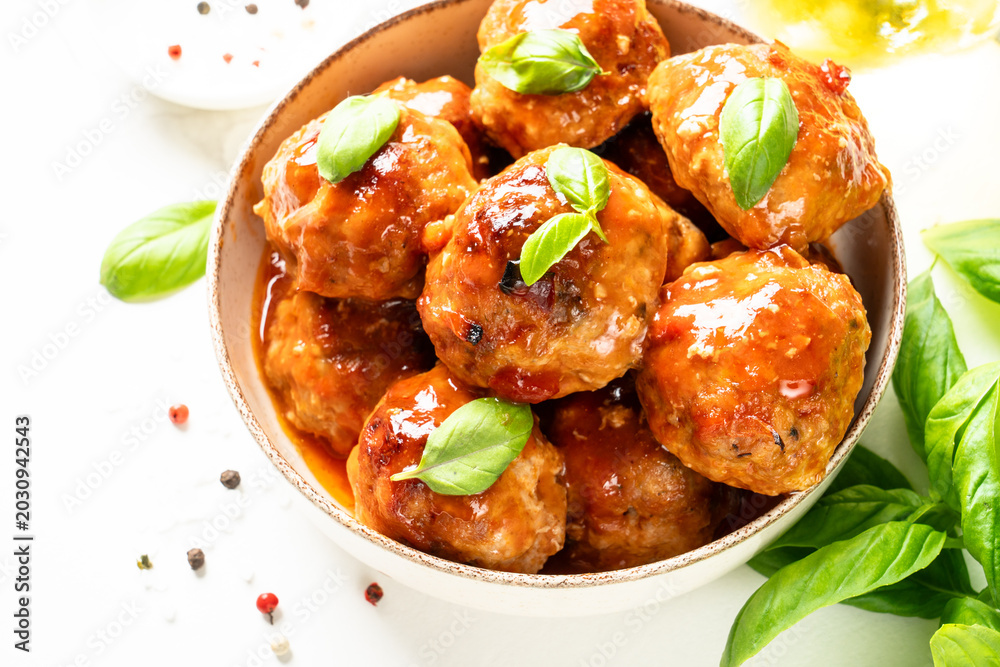 Fototapeta premium Meatballs in tomato sauce in iron plate on black background.