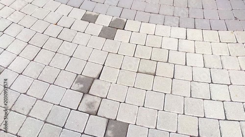 Top view of the surface of a pedestrian path with paving slabs. New cobblestone pavement close up. Traditional stone pavement. 