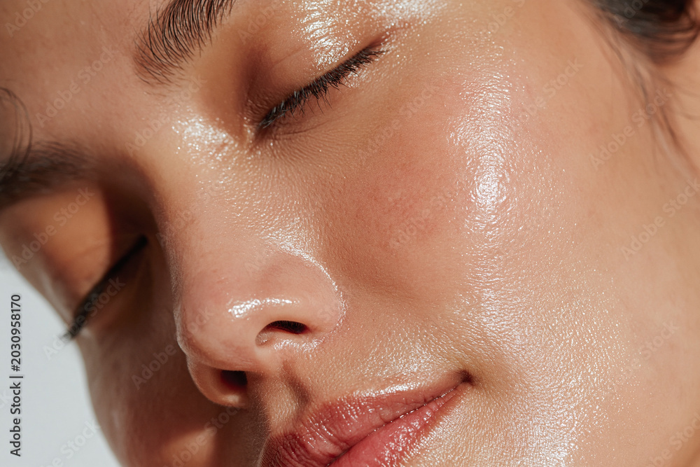 Fototapeta premium Radiant skin texture close up portrait glowing complexion natural beauty dewy skin healthy skin moisturized skin female face closed eyes soft lighting