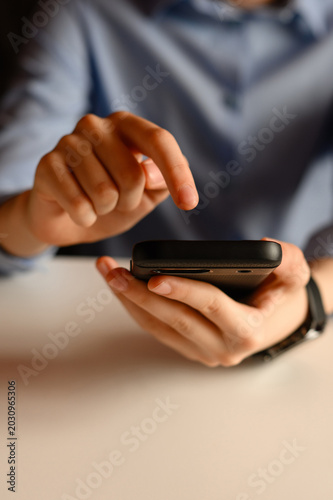 Conceptual background of men's hands with a smartphone for online shopping. Men's hands with a phone