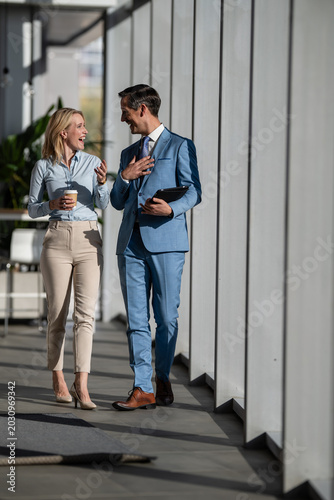 Fotografie Business colleagues walking talking having informal conversation