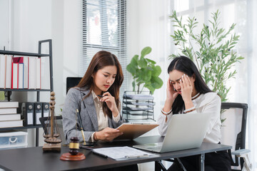 Legal Consultation and Distress: Two professional women in a legal setting, one offering consultation while the other shows clear signs of distress and anxiety.