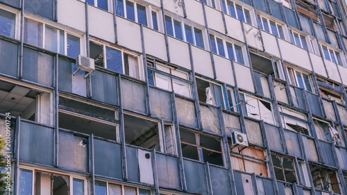 Billede på lærred Urban building facade with broken windows and visible air conditioning units