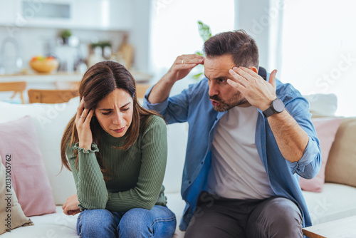 Upset Couple Arguing in Living Room, Relationship Conflict and Emotional Tension Between Partners