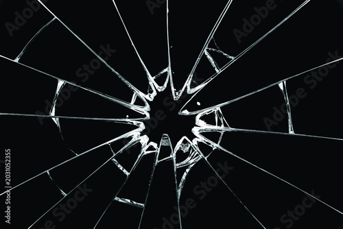 Bild auf Leinwand Broken window glass effect with radial sharp shards and cracks from impact,Shattered glass texture with bullet hole crack pattern isolated on black background